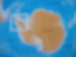 ANTICIPATION A blurred photograph of a map of Antarctica