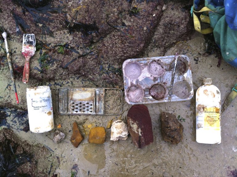 A place palette: fragments of earth, stone and litter laid out in a grid.